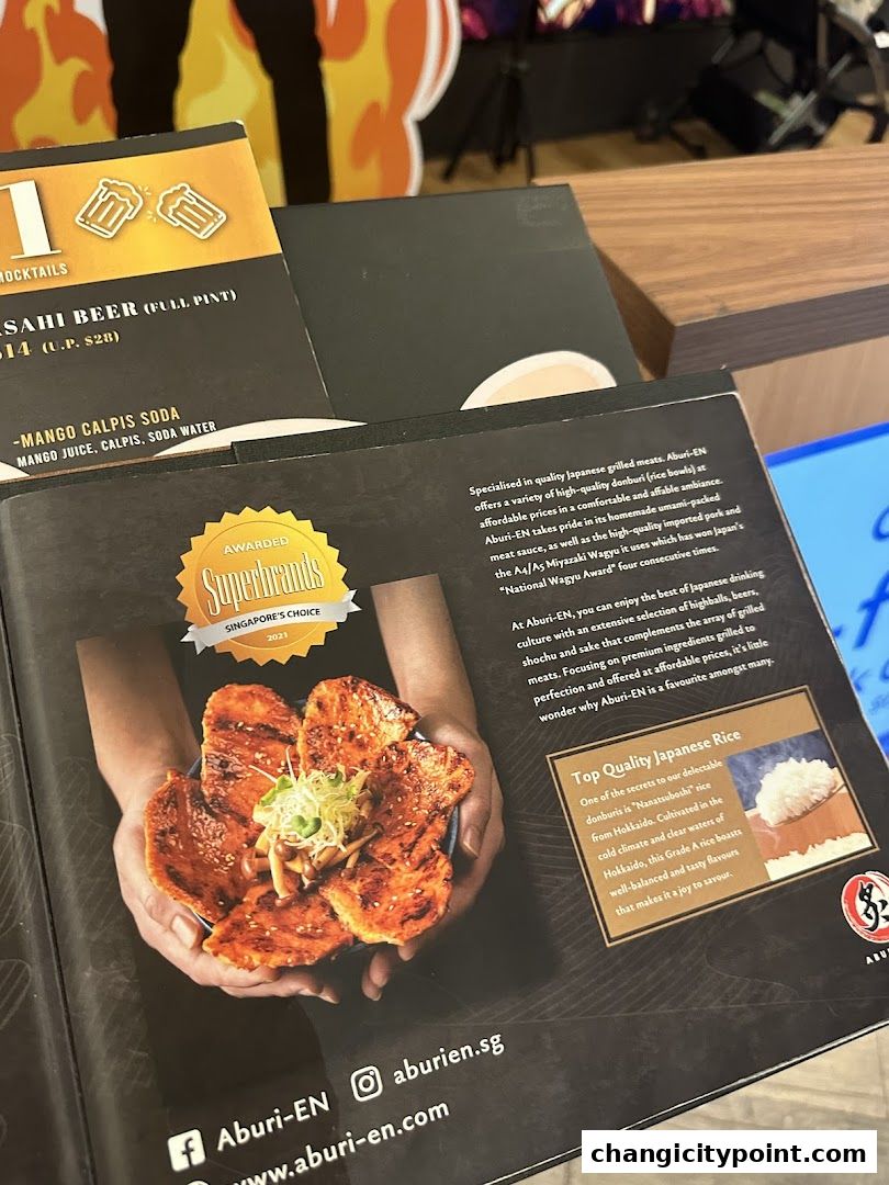 A brochure showcasing Japanese grilled meats, rice bowls, and drinks from Aburi-EN.