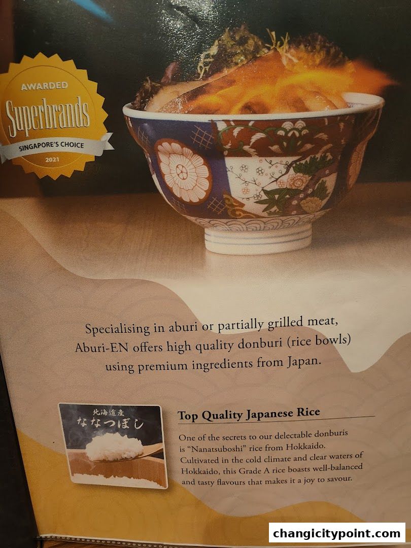 A close-up of a donburi bowl with a Superbrands award and text about Japanese rice.