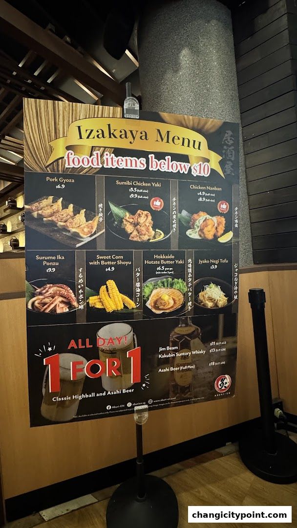 A menu board for Aburi-EN featuring Izakaya food items below $10 and drink promotions.