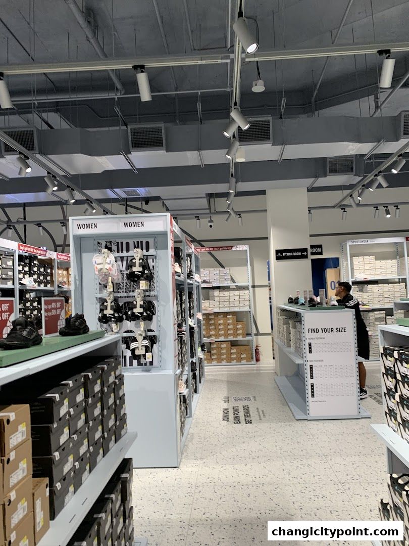 Interior view of an Adidas Factory Outlet store showcasing footwear and apparel displays.