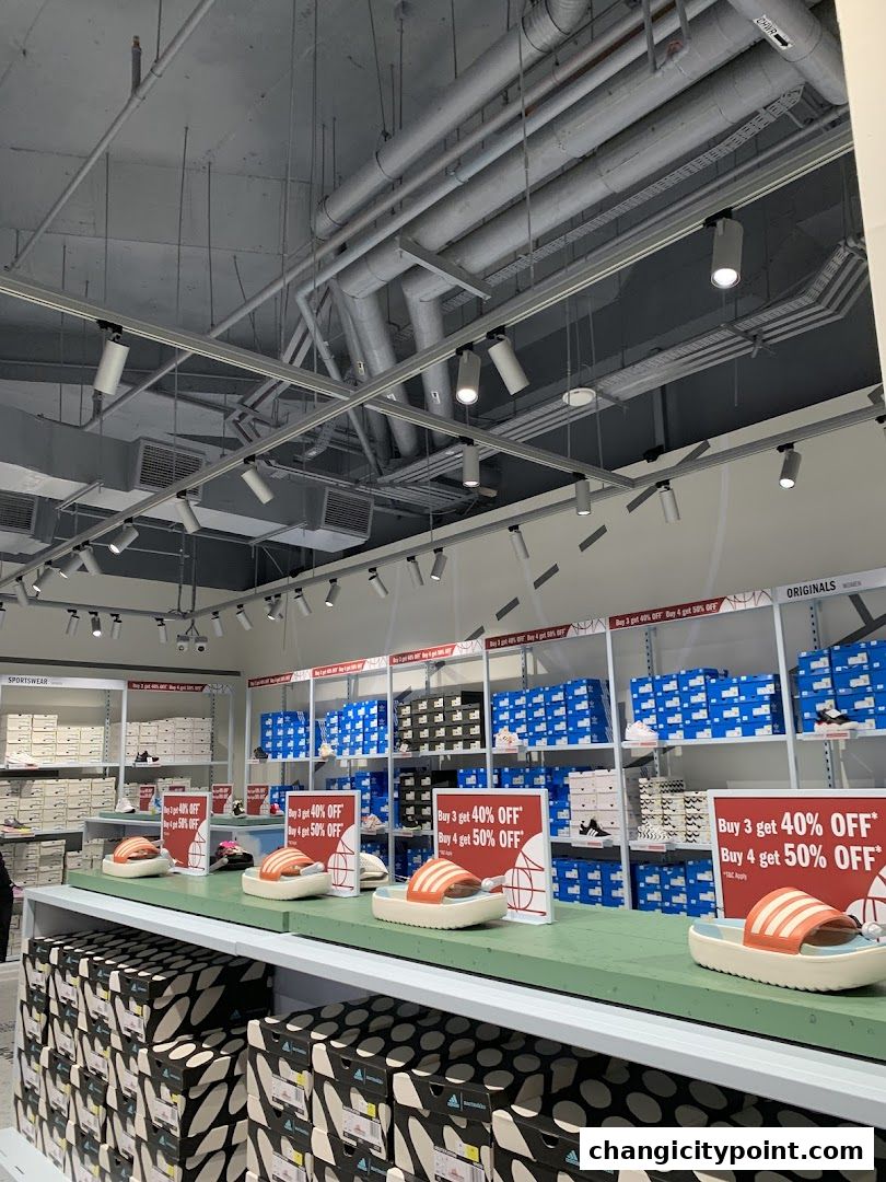 Adidas Factory Outlet with shoes and special offers displayed.