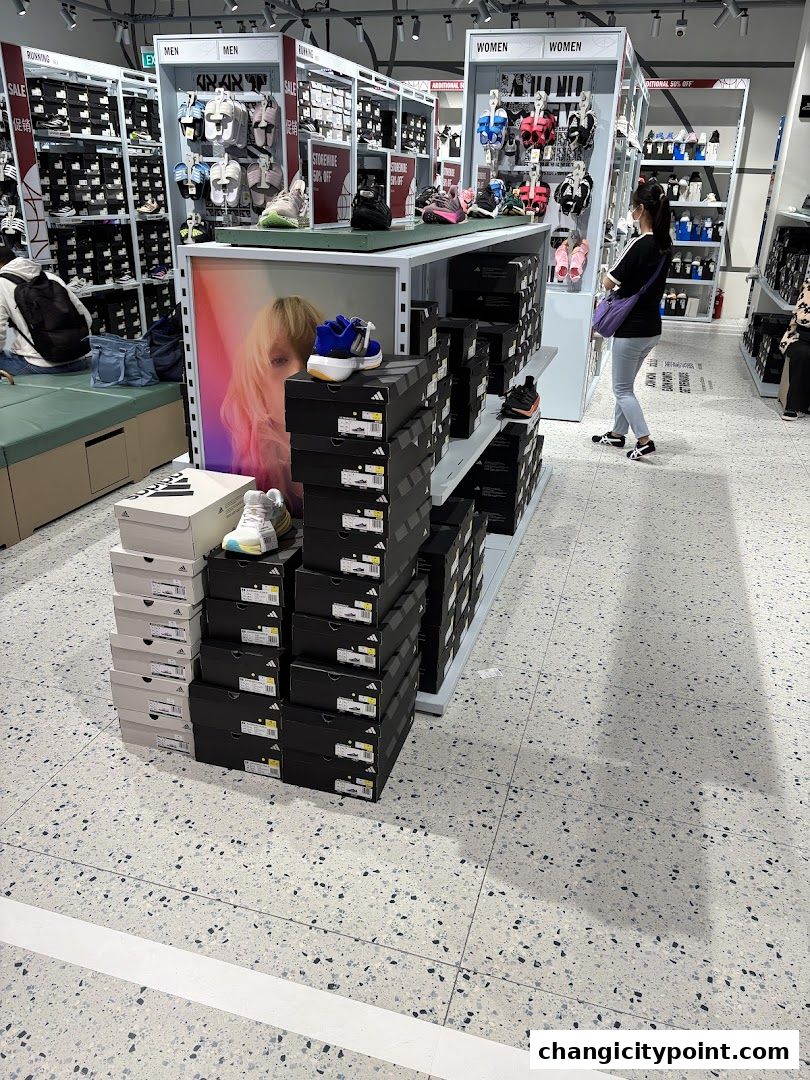 Interior view of an Adidas Factory Outlet store showcasing shoes and boxes.