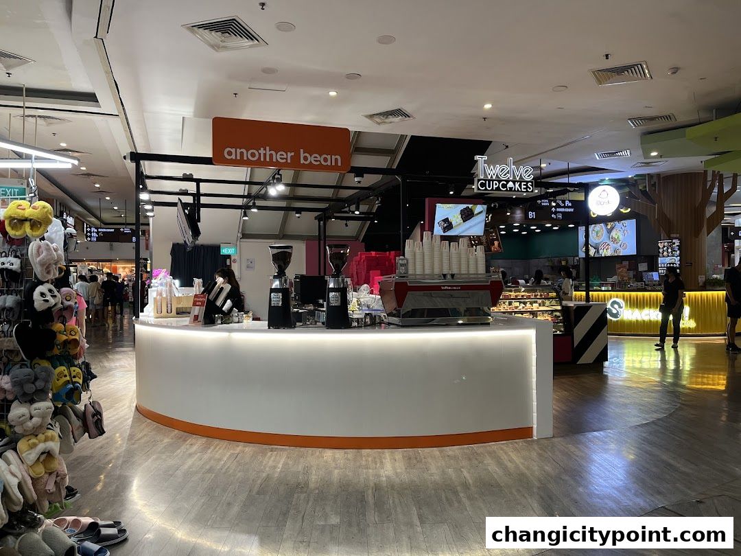 The 'another bean' coffee shop counter with espresso machines and grinders.