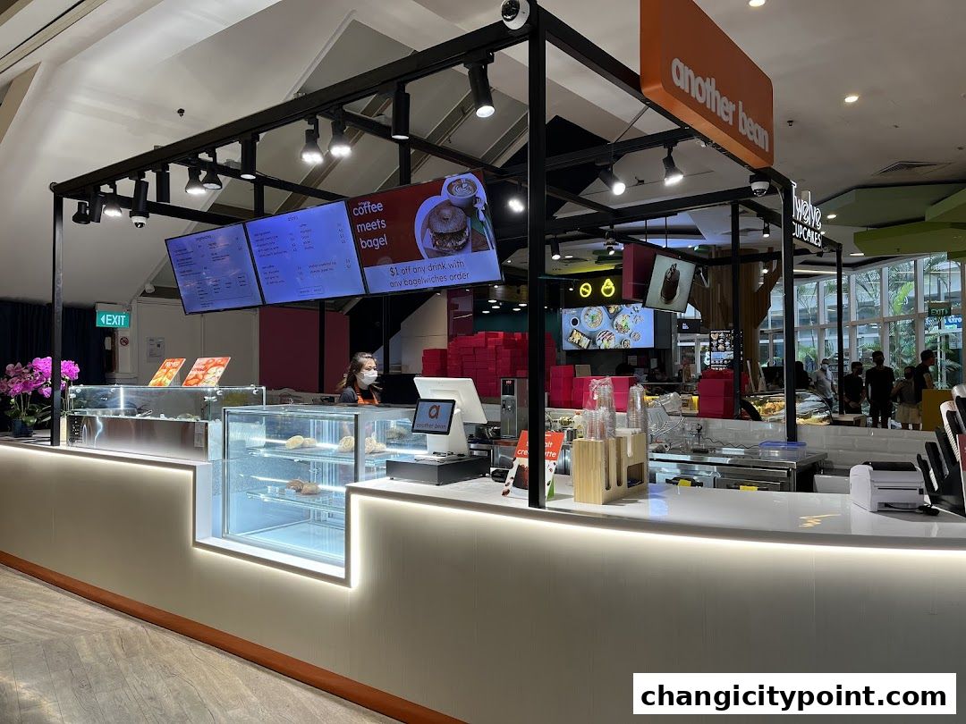 The exterior of 'another bean' cafe, showcasing its counter, menu boards, and display cases.