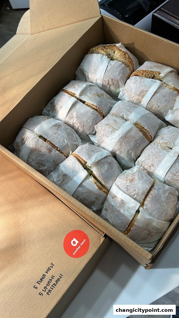 A box filled with individually wrapped sandwiches, likely from 'another bean'.