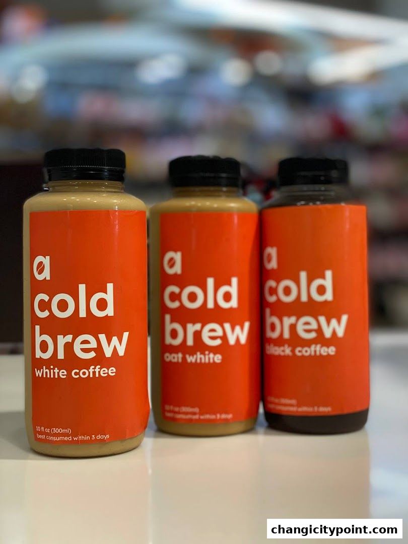 Three bottles of 'a cold brew' coffee in white coffee, oat white, and black coffee flavors.