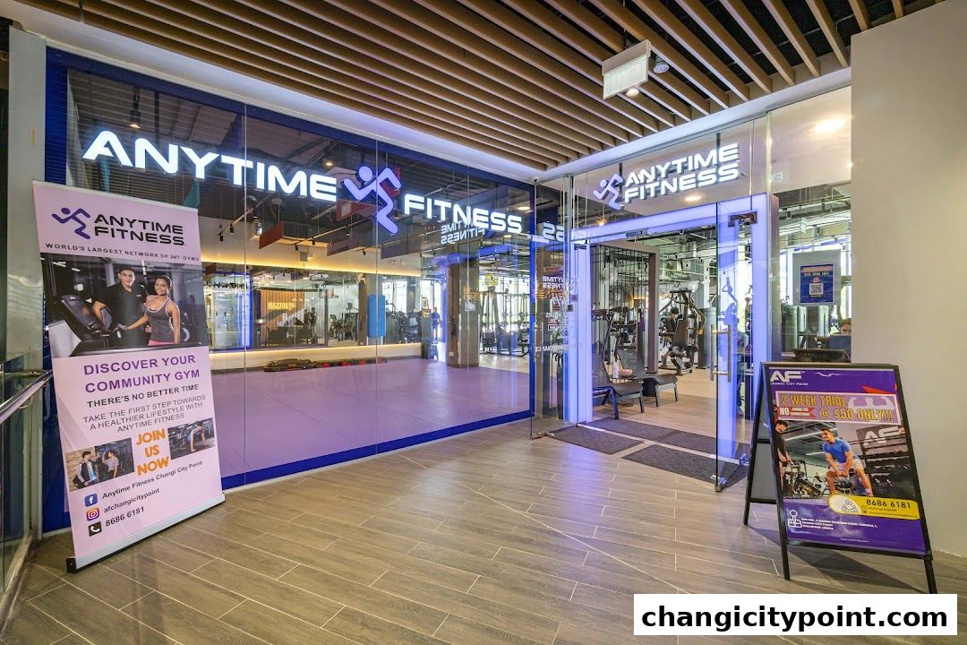 The entrance of Anytime Fitness Changi gym with a banner and a promotional sign.