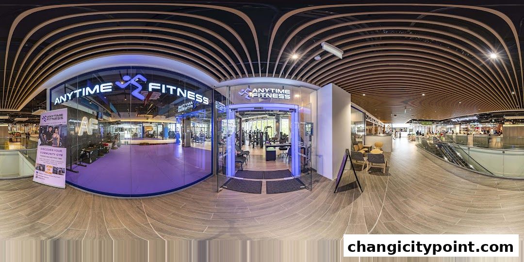 Entrance to Anytime Fitness Changi gym with modern interior and equipment visible.