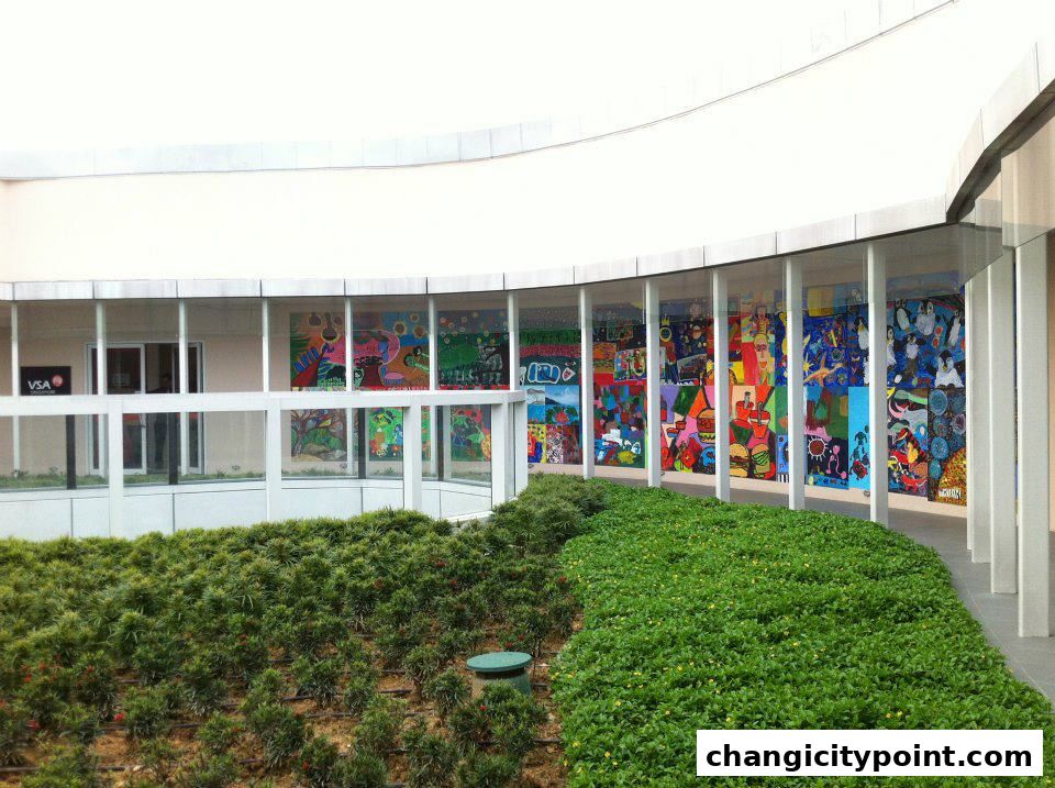 Exterior of ARTDIS C C P shop with colorful artwork displayed behind glass windows.