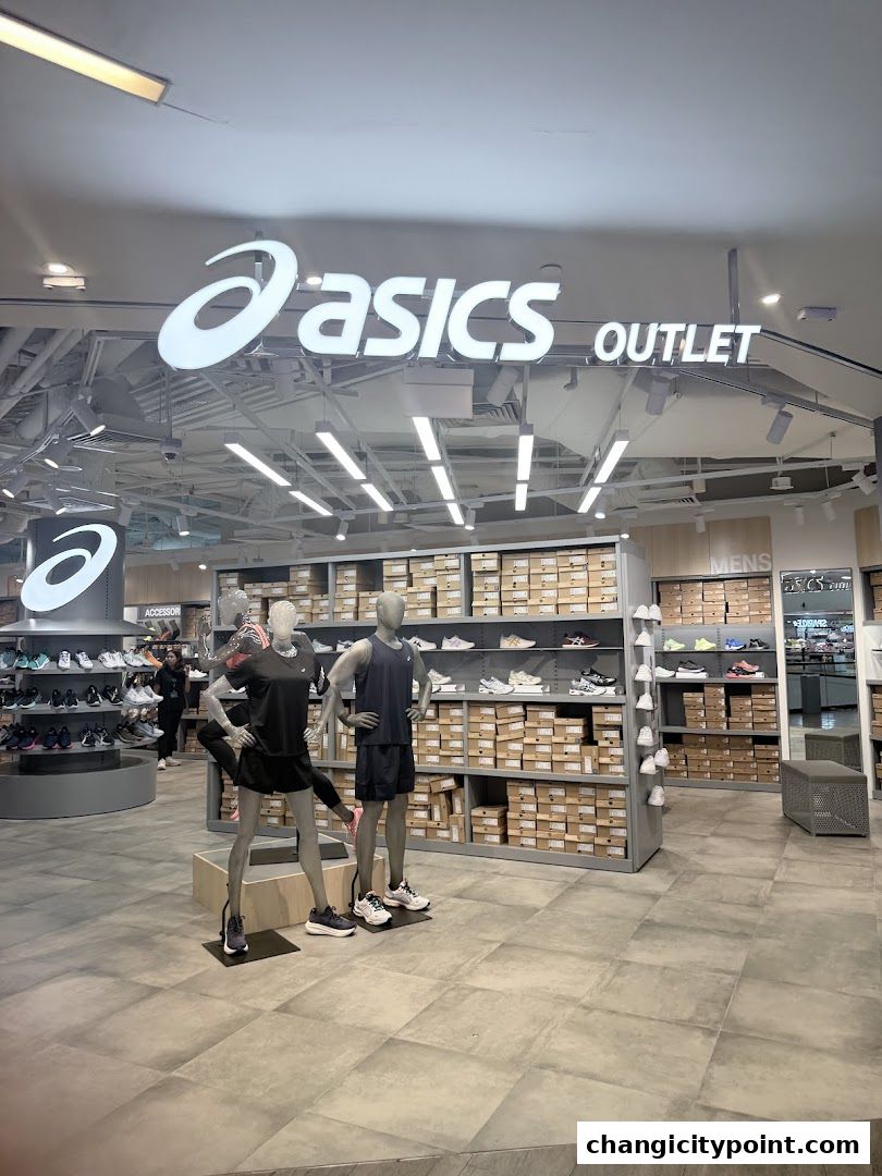 Interior view of an ASICS Outlet store showcasing shoes and apparel on display.