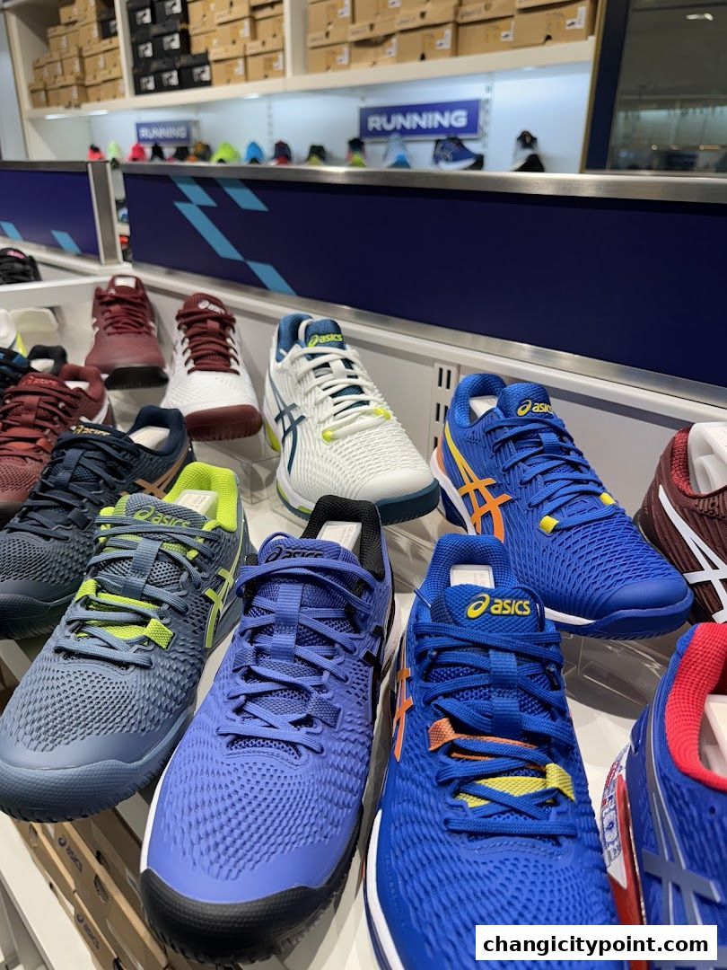 Display of various ASICS running and athletic shoes in an outlet store.