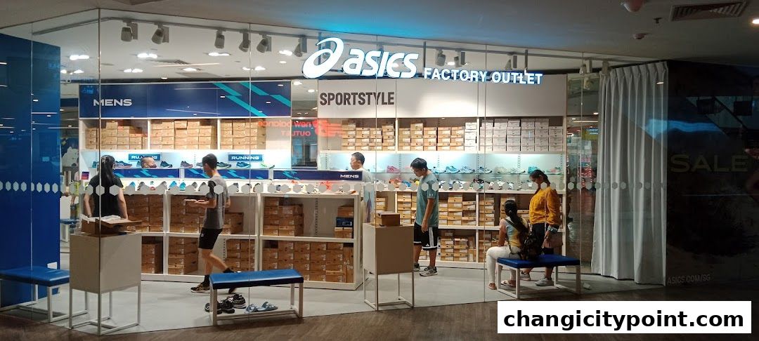 The ASICS Factory Outlet store entrance displays shoes and boxes, with customers browsing.