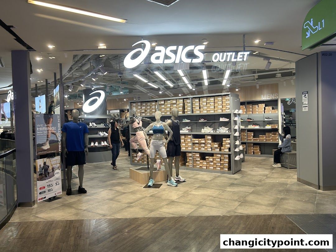 The entrance of an ASICS Outlet store displaying shoes and mannequins.