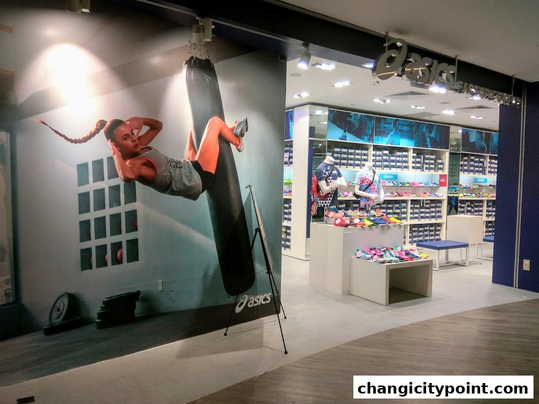 The entrance of an ASICS Outlet store displaying athletic shoes and apparel.