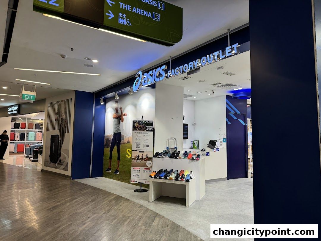 The ASICS Factory Outlet store entrance with shoes displayed and promotional signs.