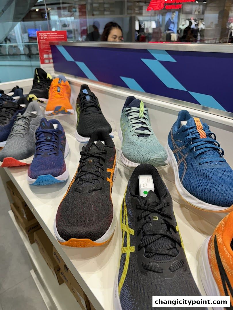A display of various ASICS running shoes in different colors and styles.