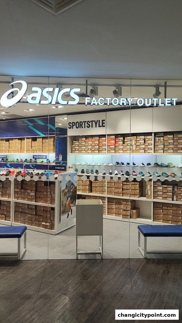 ASICS Factory Outlet store entrance showcasing shelves filled with shoe boxes and displayed footwear.