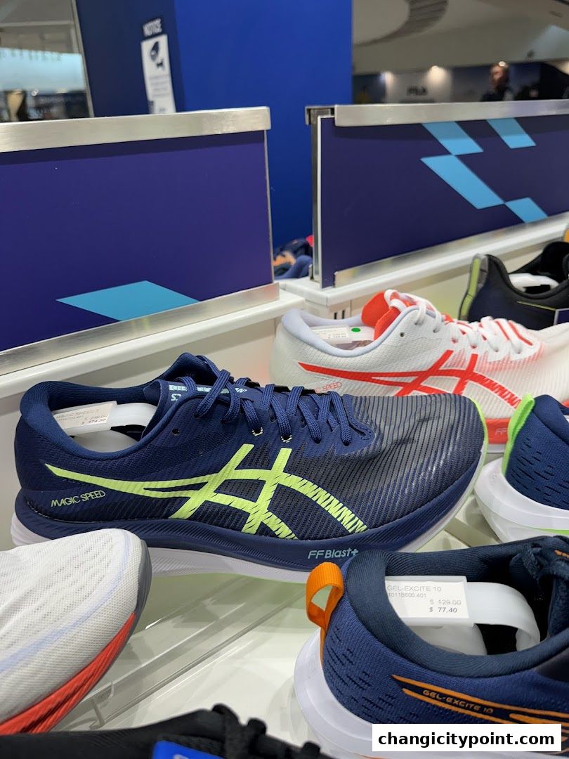 Display of ASICS running shoes, featuring the Magic Speed and Gel-Excite 10 models.