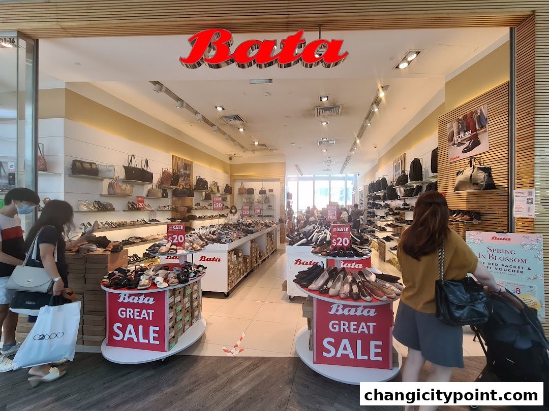 The entrance of a Bata shoe store with a large 'Great Sale' display and various shoes on shelves.
