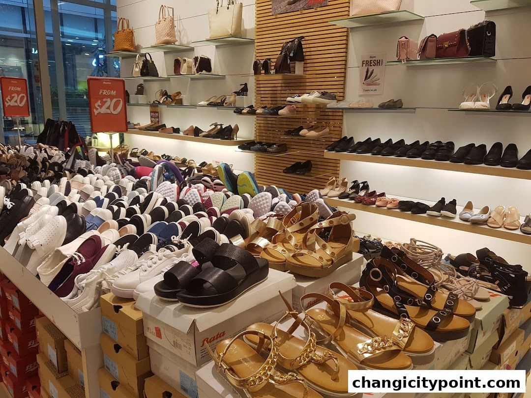 A wide selection of shoes and handbags displayed in a retail store.