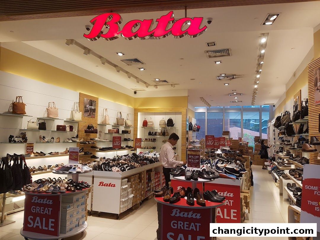 Interior view of a Bata shoe store with various footwear and sale signage.