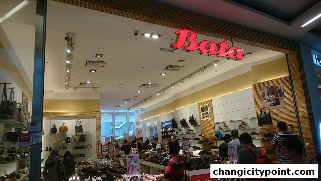 Interior view of a Bata shoe store with various footwear and bags on display.