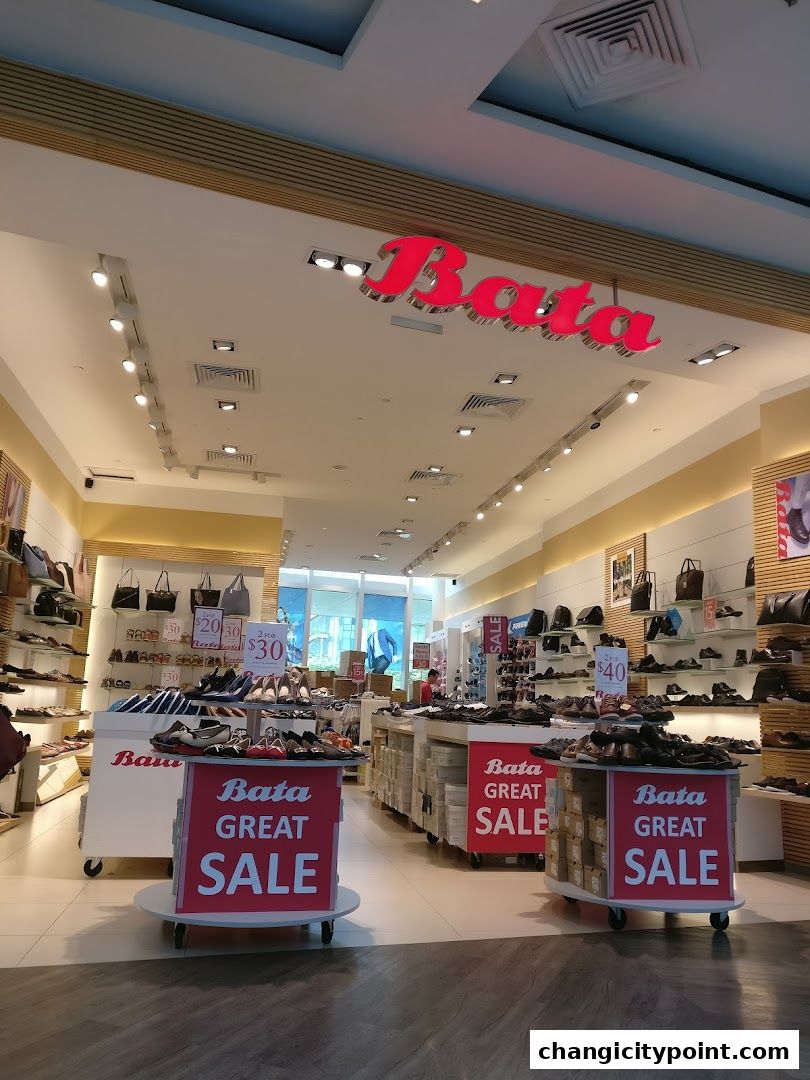 Interior view of a Bata shoe store with displays of shoes and bags, and sale signage.