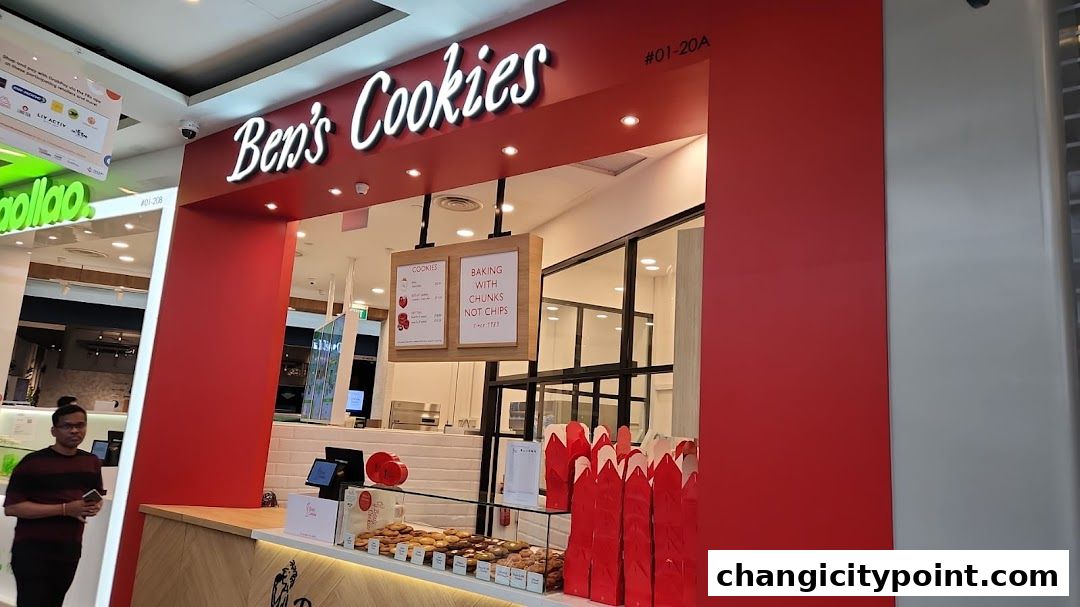 The exterior of Ben's Cookies shop with a display of cookies and red packaging.
