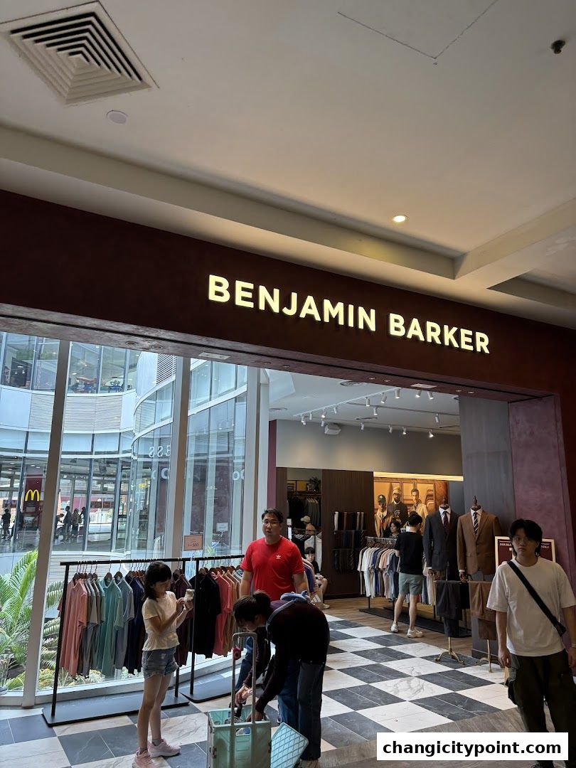 Benjamin Barker store entrance with clothing displays and shoppers.