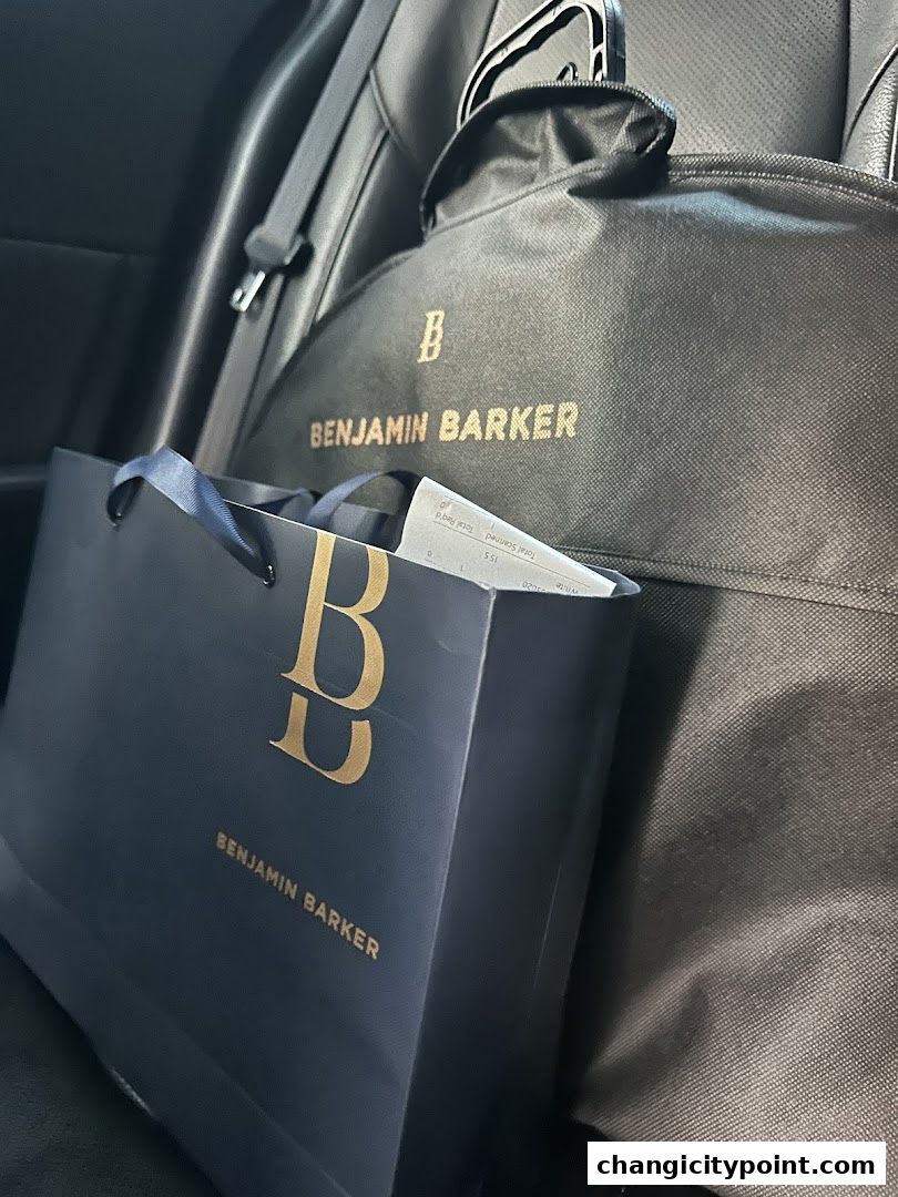 Benjamin Barker shopping bag and garment bag in a car.