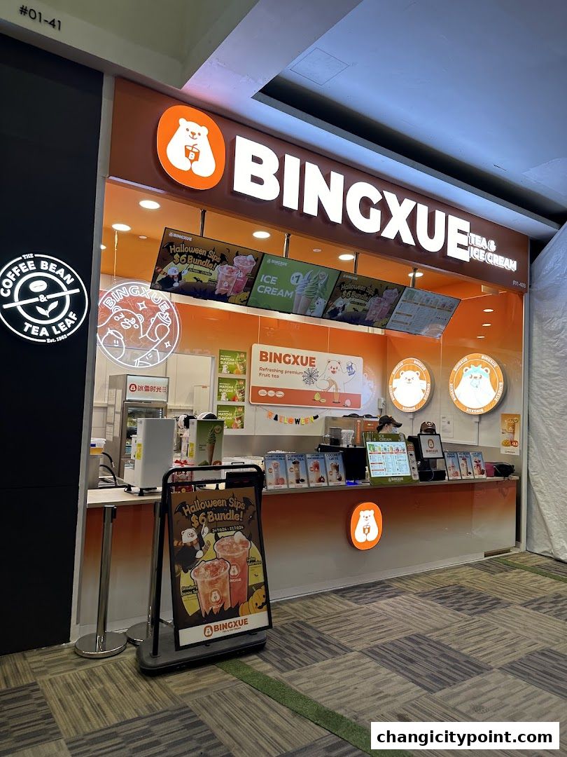 BingXue Tea & Ice Cream shop front with bright orange branding and promotional displays.