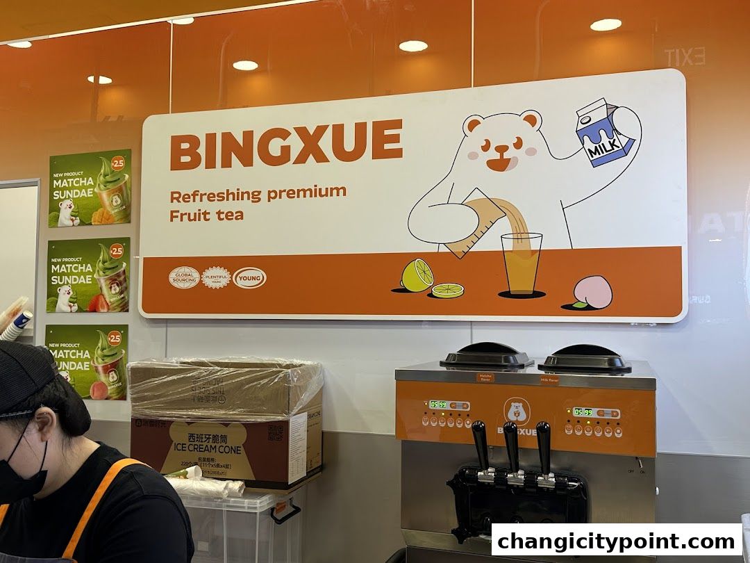 BingXue Tea Ice Cream shop interior with branding, soft serve machine, and ice cream cones.