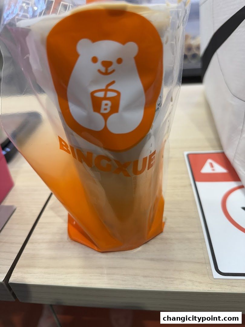 A BingXue Tea drink with a cute polar bear logo on its packaging.