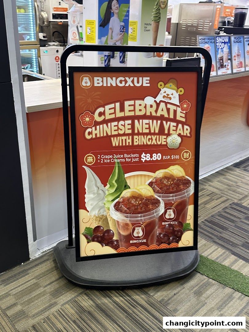 A promotional sign for BingXue celebrating Chinese New Year with a drink and ice cream offer.