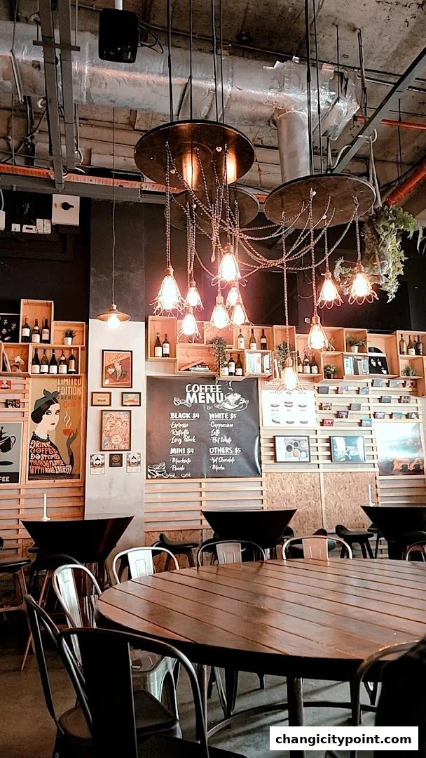 Interior of a coffee shop with a menu board, wooden shelves, and seating.