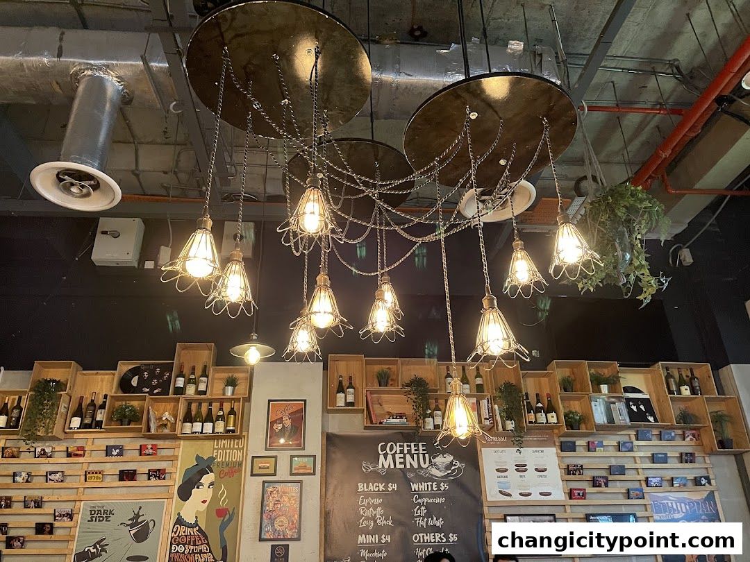 Interior shot of BLVD Changi cafe with unique lighting and shelves of coffee-related items.
