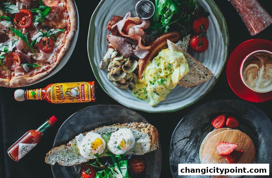 A spread of delicious breakfast and brunch dishes, including pizza, scrambled eggs, pancakes, and coffee.