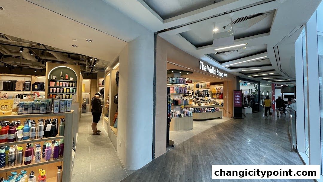 Interior view of a retail shop selling wallets, bags, and water bottles.