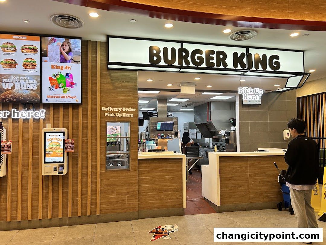 Burger King storefront with digital menu boards, ordering kiosk, and pickup counter.