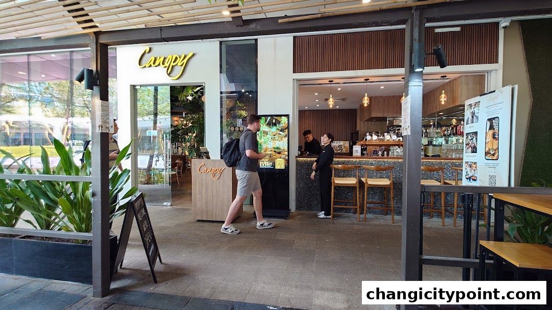 Exterior view of Canopy Changi City Point cafe with patrons and staff visible.