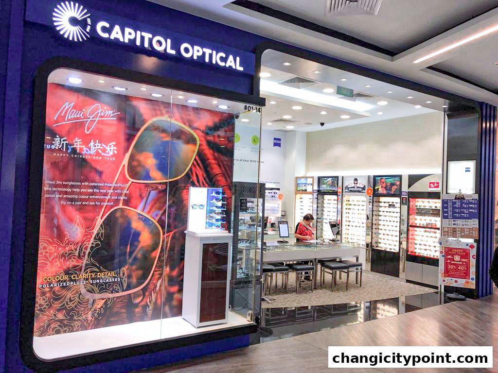 Capitol Optical shop front with a display of Maui Jim sunglasses and various eyewear inside.