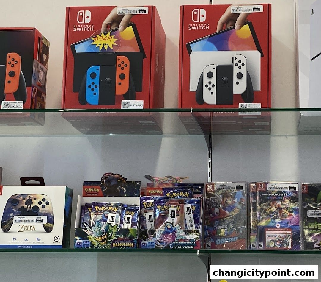 Shelves display Nintendo Switch consoles, games, and Pokemon trading cards.