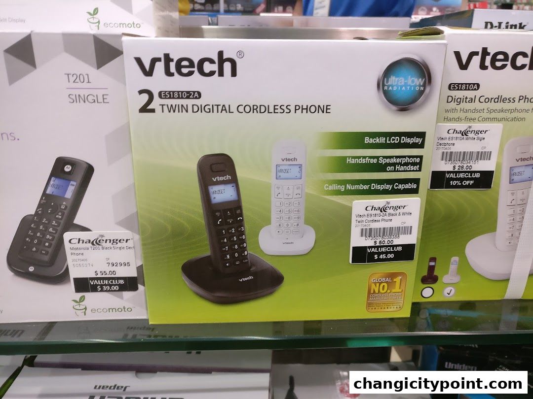 Product packaging for Vtech and Motorola cordless phones displayed in a retail store.