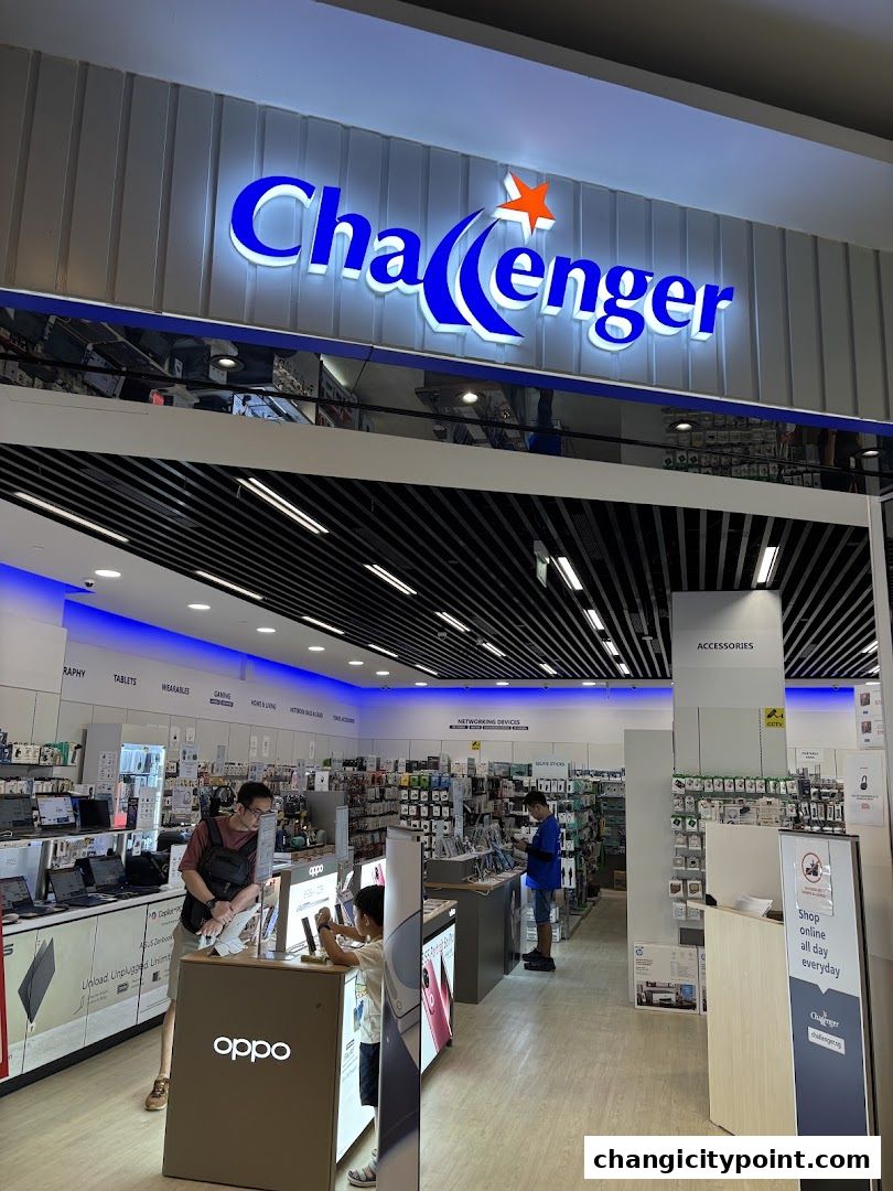The exterior of a Challenger electronics store with a prominent sign and displays of electronics inside.