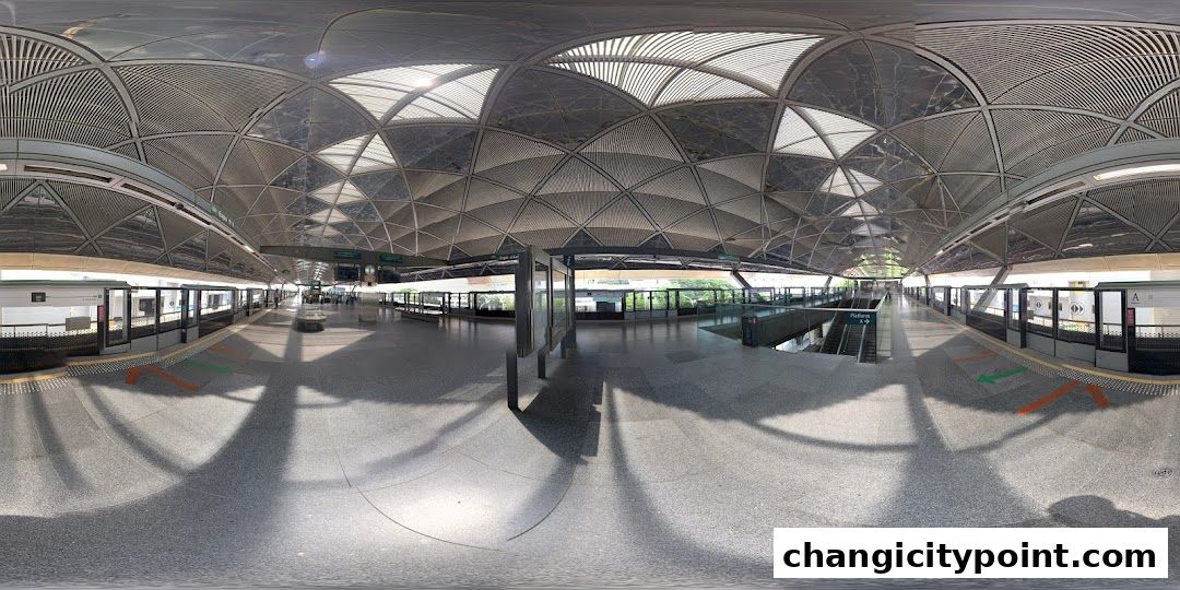 A panoramic view of a modern, covered train station platform with sleek architecture.