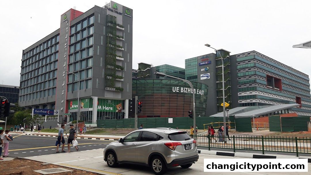 Modern buildings with green facades and signage for UE Bizhub East.