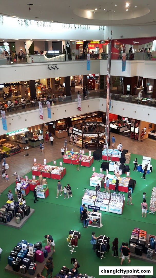 An aerial view of a busy shopping mall with various retail displays and shoppers.
