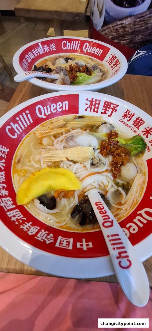 Two bowls of delicious rice noodle soup with various toppings from Chilli Queen.