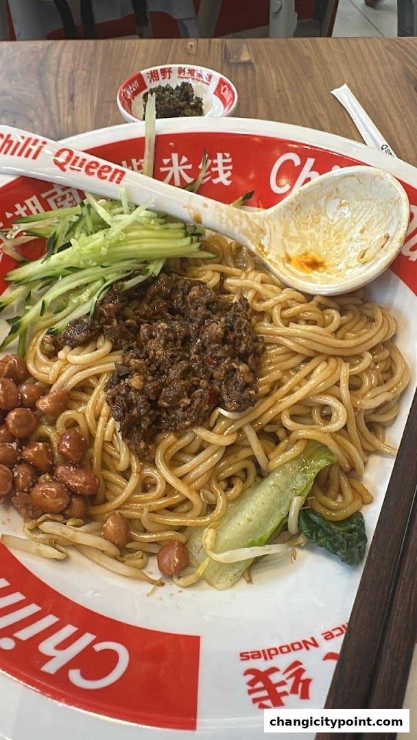 A bowl of delicious rice noodles with minced meat, peanuts, cucumber, and sprouts.