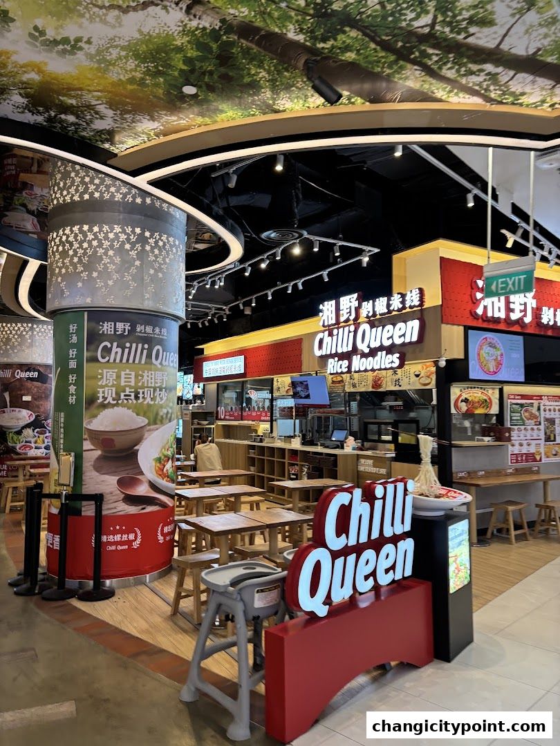 Chilli Queen Rice Noodles shop front with seating and prominent signage.